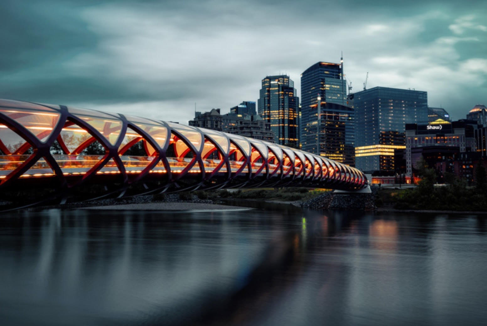 Calgary skyline with a modern bridge at dusk